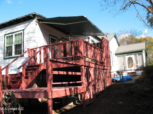 view of property exterior featuring a wooden deck