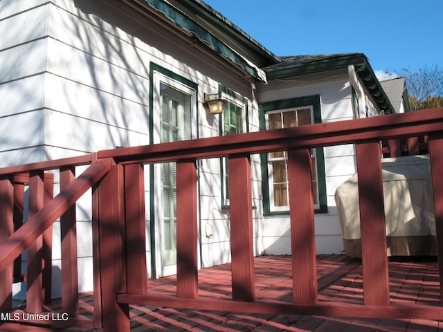 view of side of home with a wooden deck