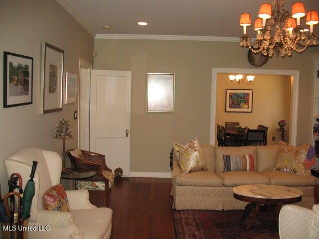 living room with crown molding, hardwood / wood-style floors, and a notable chandelier