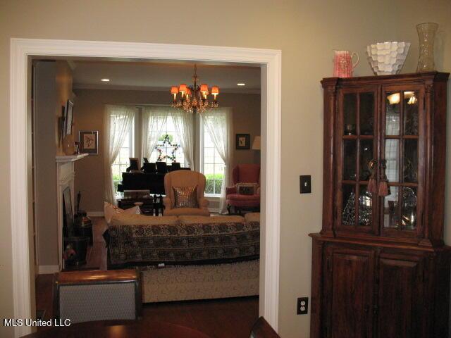 dining space with crown molding and a chandelier