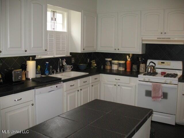 kitchen featuring backsplash, white appliances, range hood, and sink