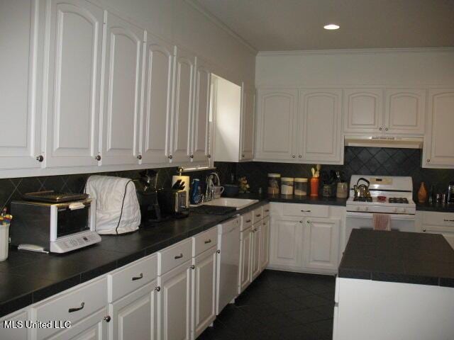 kitchen with white appliances, crown molding, sink, tasteful backsplash, and white cabinetry