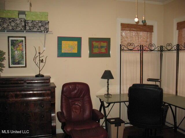 living area with crown molding