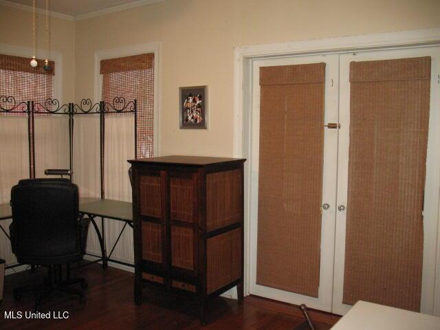 interior space featuring french doors, dark hardwood / wood-style flooring, and crown molding