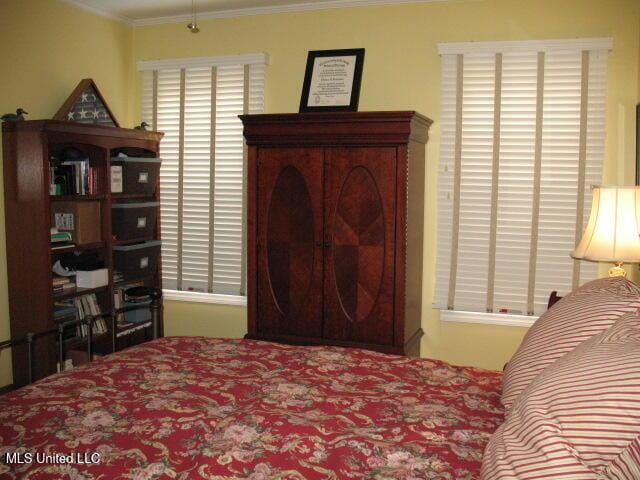 bedroom featuring crown molding