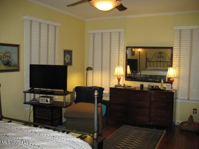 bedroom featuring hardwood / wood-style flooring, ceiling fan, and ornamental molding