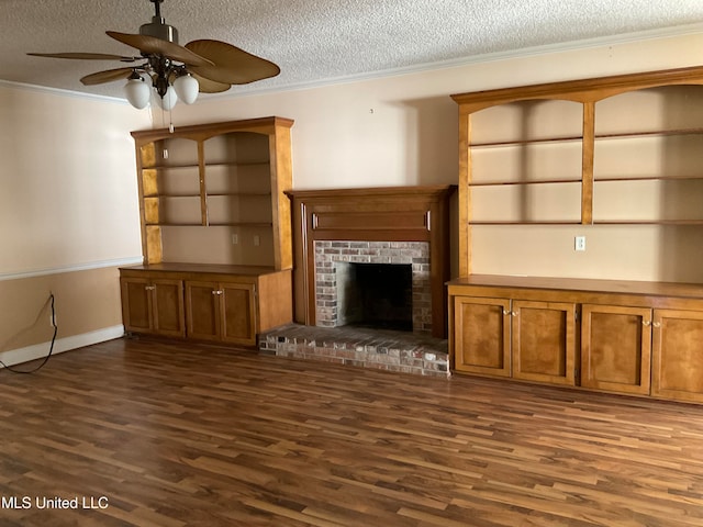 unfurnished living room featuring crown molding, a fireplace, dark wood-type flooring, and a textured ceiling