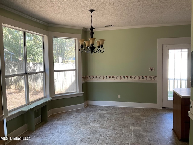 unfurnished dining area featuring a wealth of natural light, crown molding, a chandelier, and a textured ceiling