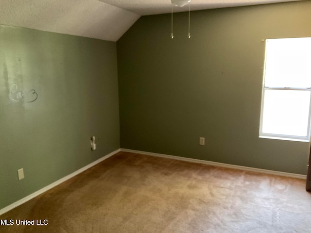 bonus room featuring lofted ceiling and light carpet