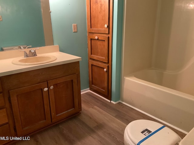 full bathroom with wood-type flooring, vanity, toilet, and shower / tub combination