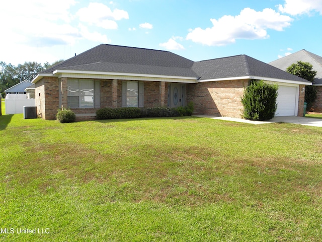 ranch-style house featuring a garage, central air condition unit, and a front lawn