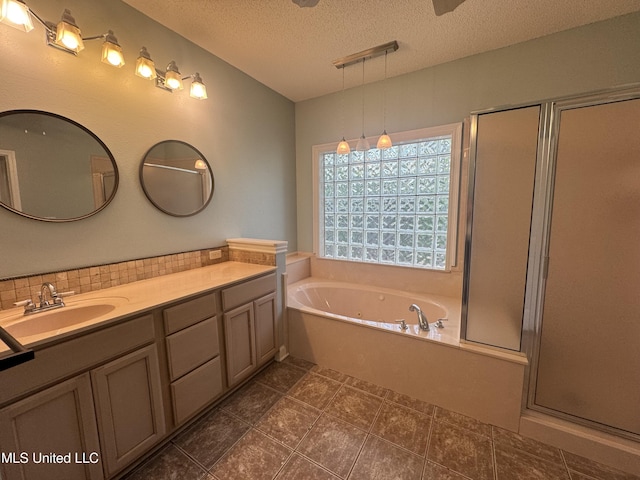 730 Ieke Cir, Diamondhead, MS 39525 - full bath featuring double vanity, a textured ceiling, a shower stall, a garden tub, and decorative backsplash