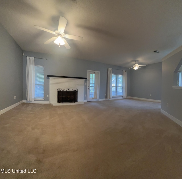 730 Ieke Cir, Diamondhead, MS 39525 - unfurnished living room featuring a ceiling fan, a fireplace with raised hearth, and light colored carpet