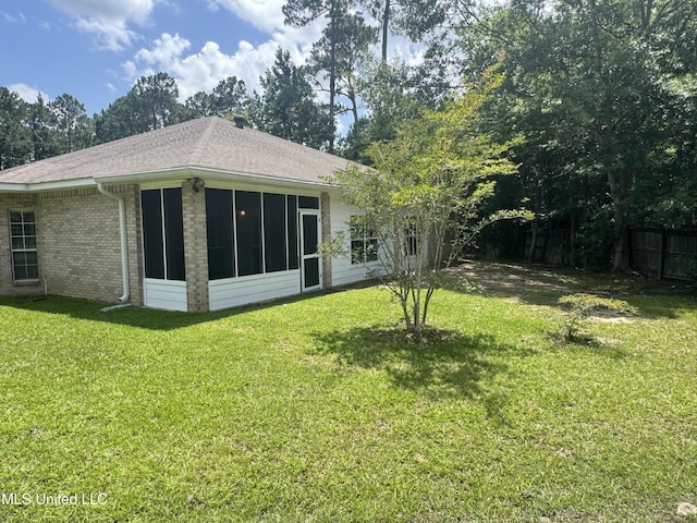 730 Ieke Cir, Diamondhead, MS 39525 - rear view of property featuring a sunroom, roof with shingles, and brick siding
