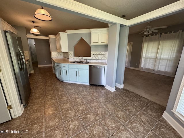 730 Ieke Cir, Diamondhead, MS 39525 - kitchen with appliances with stainless steel finishes, decorative backsplash, ornamental molding, a textured ceiling, and ceiling fan