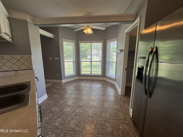 730 Ieke Cir, Diamondhead, MS 39525 - kitchen featuring stainless steel refrigerator with ice dispenser, ceiling fan, white cabinetry, a textured ceiling, and light countertops