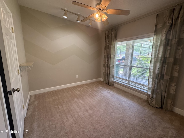 730 Ieke Cir, Diamondhead, MS 39525 - carpeted spare room with track lighting and a ceiling fan