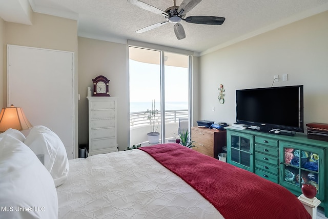 bedroom with a textured ceiling, ceiling fan, and crown molding