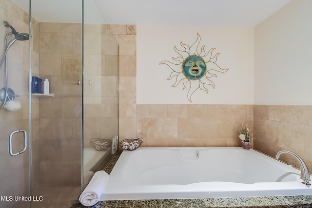 full bathroom featuring a stall shower and a garden tub