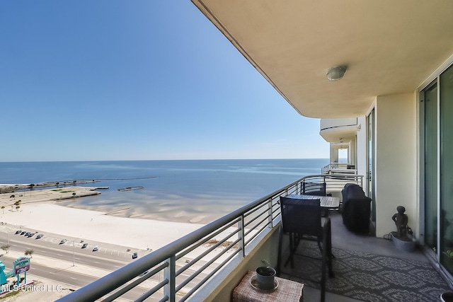 balcony featuring grilling area and a water view