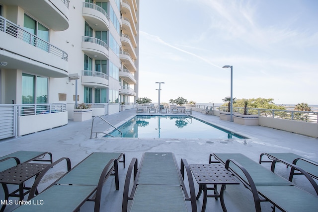 community pool with a patio area