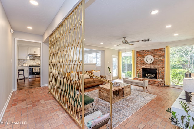 living room featuring brick floor, a fireplace, recessed lighting, visible vents, and baseboards