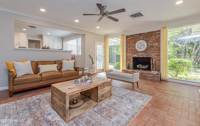 living room with ornamental molding, brick floor, visible vents, and recessed lighting