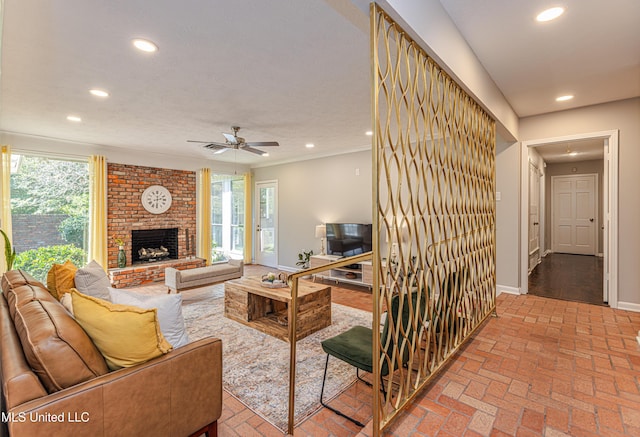 living area with brick floor, a brick fireplace, baseboards, and recessed lighting