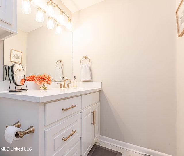 bathroom with vanity and baseboards