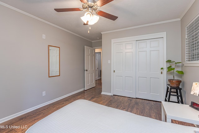 bedroom with crown molding, wood finished floors, and baseboards