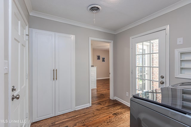 bedroom featuring baseboards, dark wood finished floors, visible vents, and crown molding