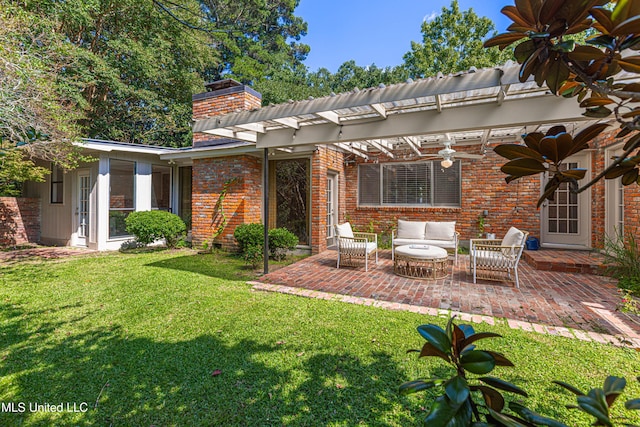 back of property featuring brick siding, a lawn, an outdoor living space, and a patio