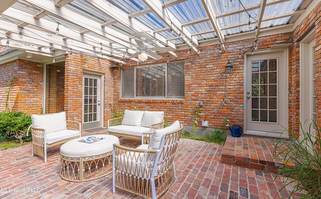 view of patio / terrace featuring ceiling fan, an outdoor living space, and a pergola