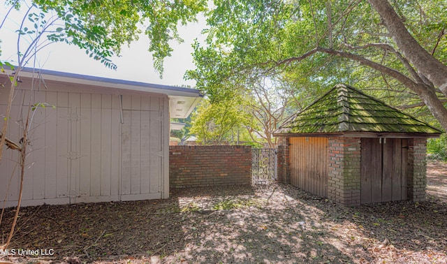 view of shed with fence