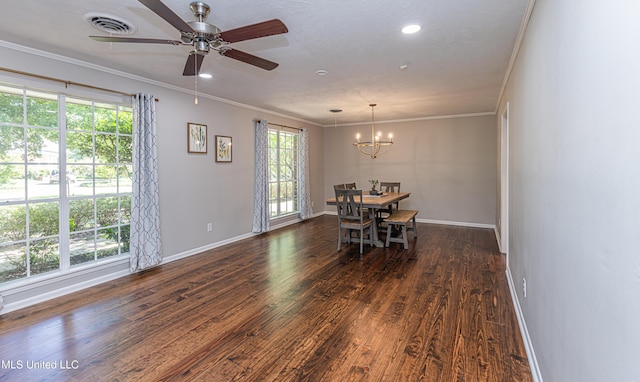 dining room with dark wood-type flooring, visible vents, crown molding, and baseboards