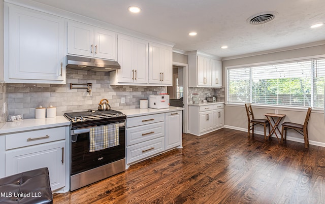 kitchen with under cabinet range hood, visible vents, light countertops, dark wood-style floors, and gas stove