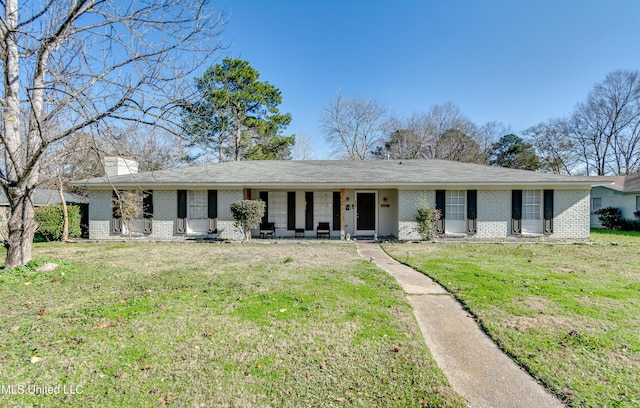 ranch-style home with a front lawn