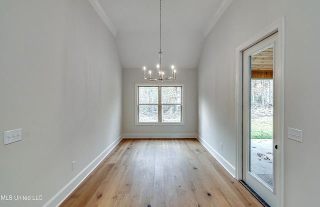 interior space with light hardwood / wood-style floors and an inviting chandelier