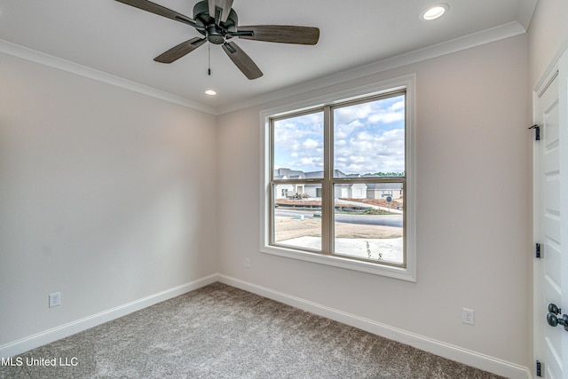 carpeted empty room with ceiling fan and crown molding