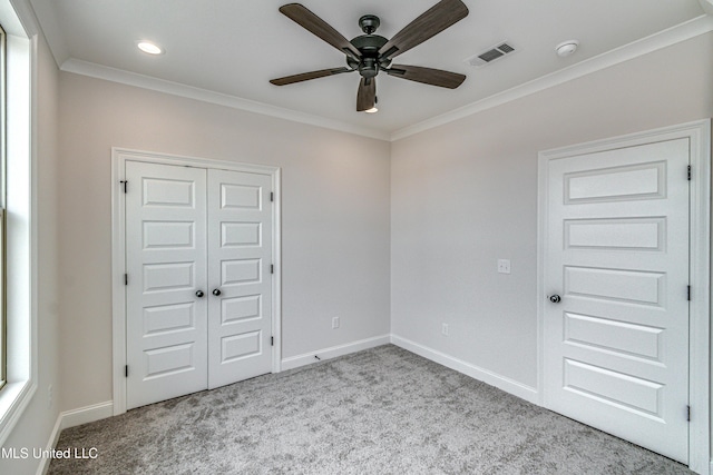 unfurnished bedroom with light carpet, a closet, ceiling fan, and ornamental molding