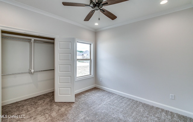 unfurnished bedroom with crown molding, ceiling fan, a closet, and light carpet