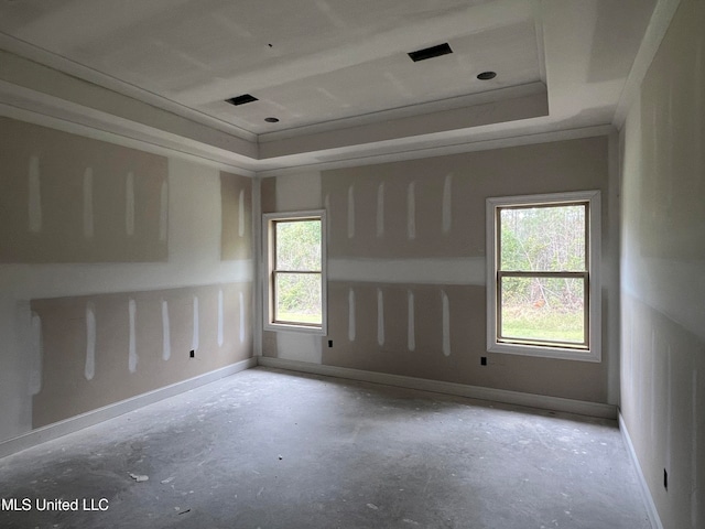 unfurnished room featuring a tray ceiling