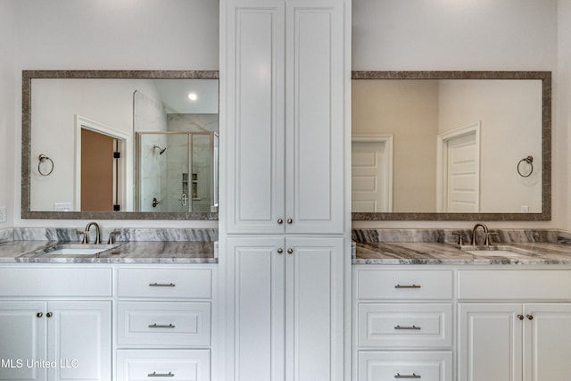 bathroom featuring vanity and an enclosed shower