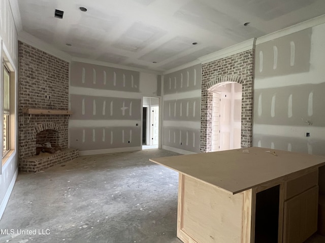 kitchen featuring a fireplace and crown molding