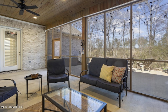 sunroom / solarium featuring a wealth of natural light, wood ceiling, and ceiling fan