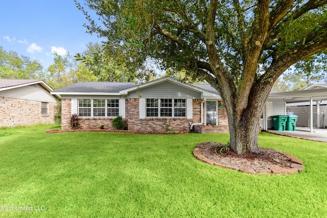 ranch-style house featuring a carport and a front yard