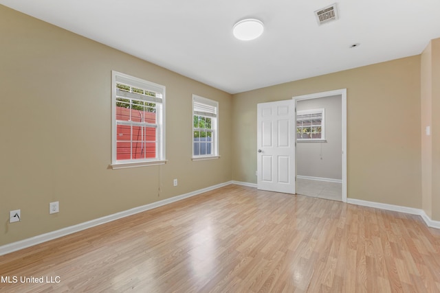 unfurnished room with light hardwood / wood-style flooring