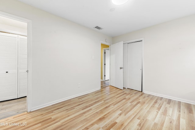 unfurnished bedroom with light hardwood / wood-style floors and a closet