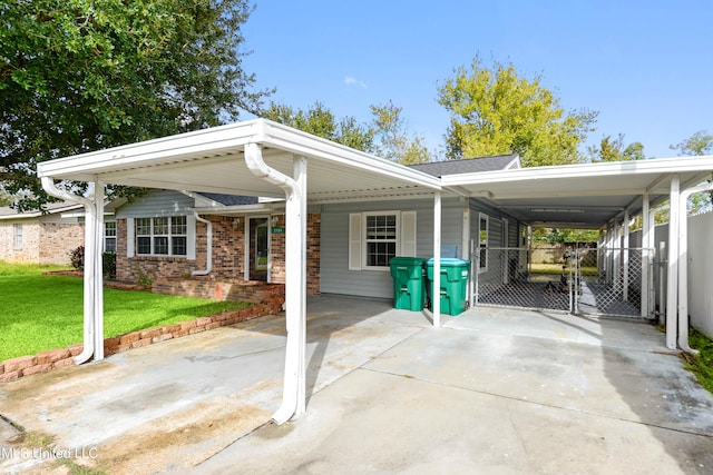 view of front of property with a front yard and a carport