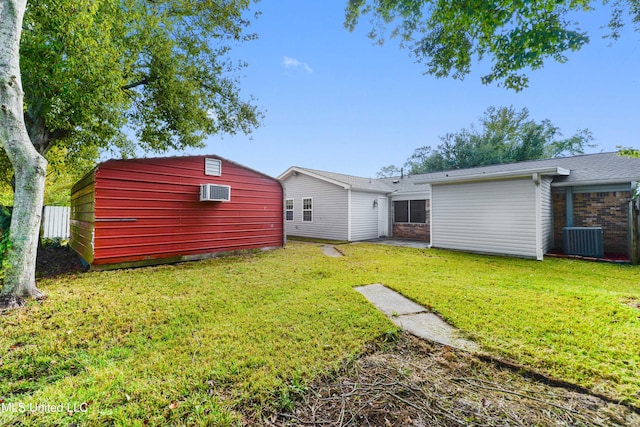 back of property featuring a lawn and cooling unit